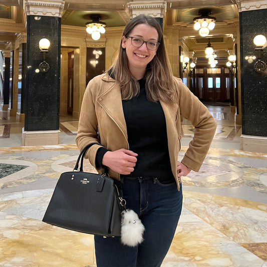 Woman in a beige coat with black alpaca inner