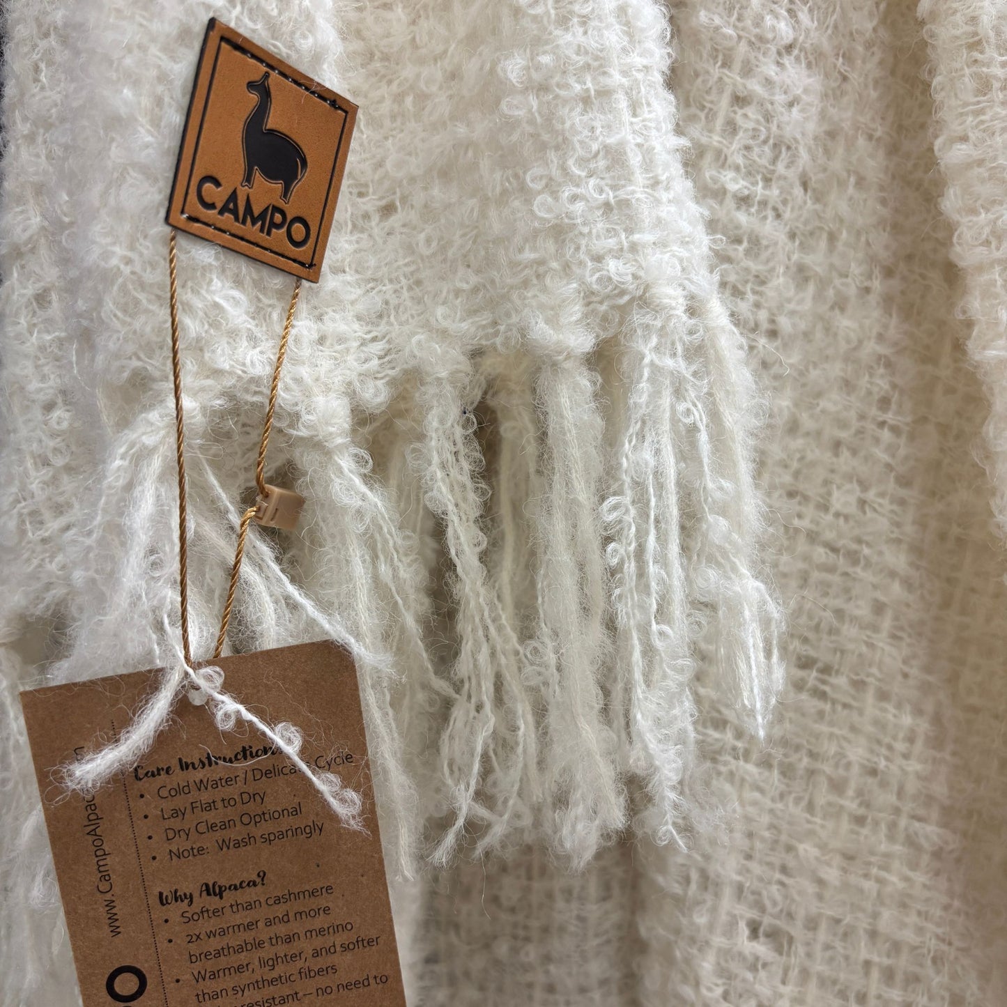 Textile product with 'Campo' label and care instructions tag on a textured background