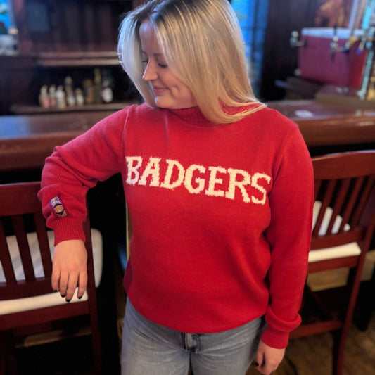 Girl wearing a red sweater with 'BADGERS' text in a casual setting
