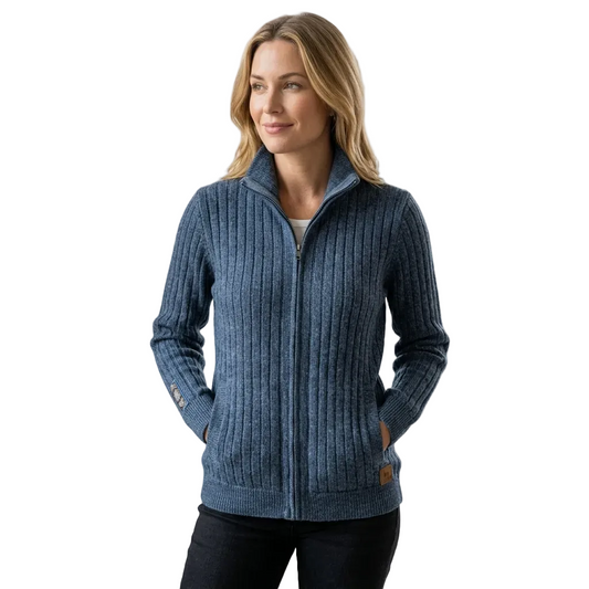 A woman wearing a blue ribbed zip-up sweater with a stand collar, shown against a plain beige background.