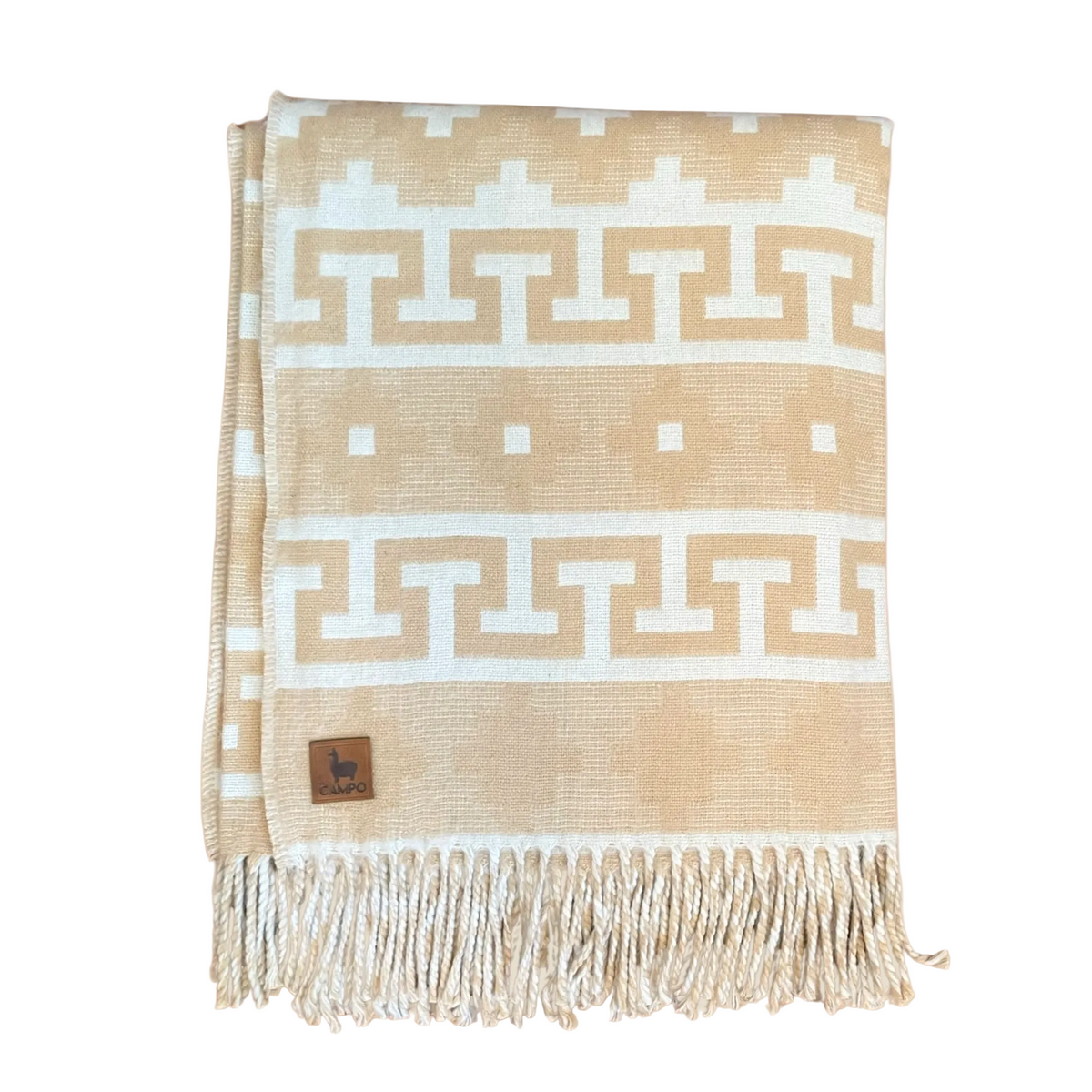 Beige and white patterned blanket with fringes on a beige background