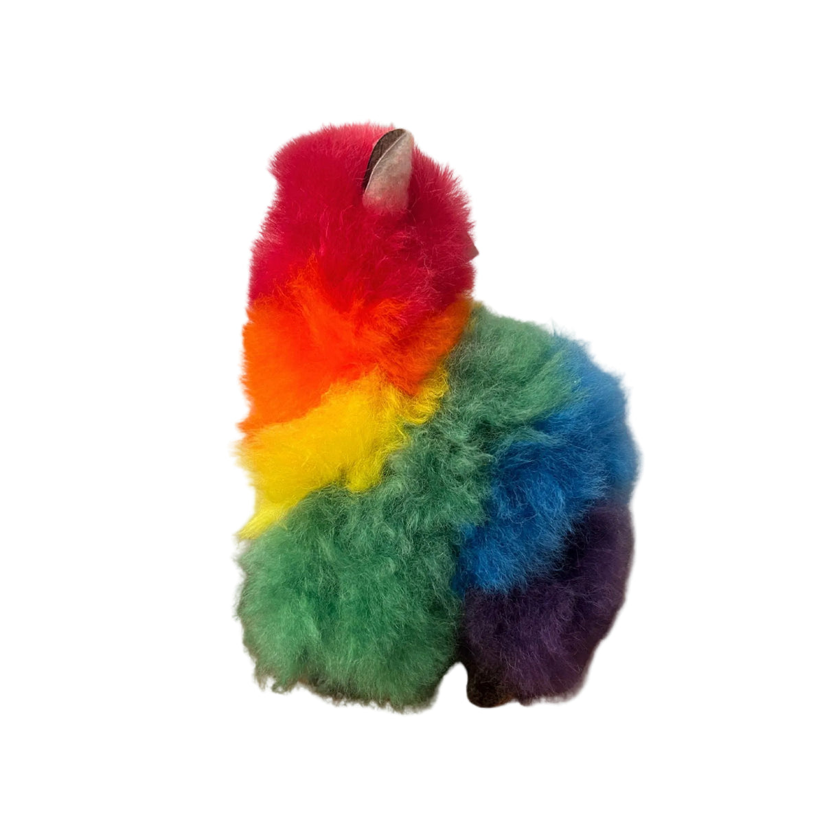 Colorful plush toy resembling a alpaca on a beige background