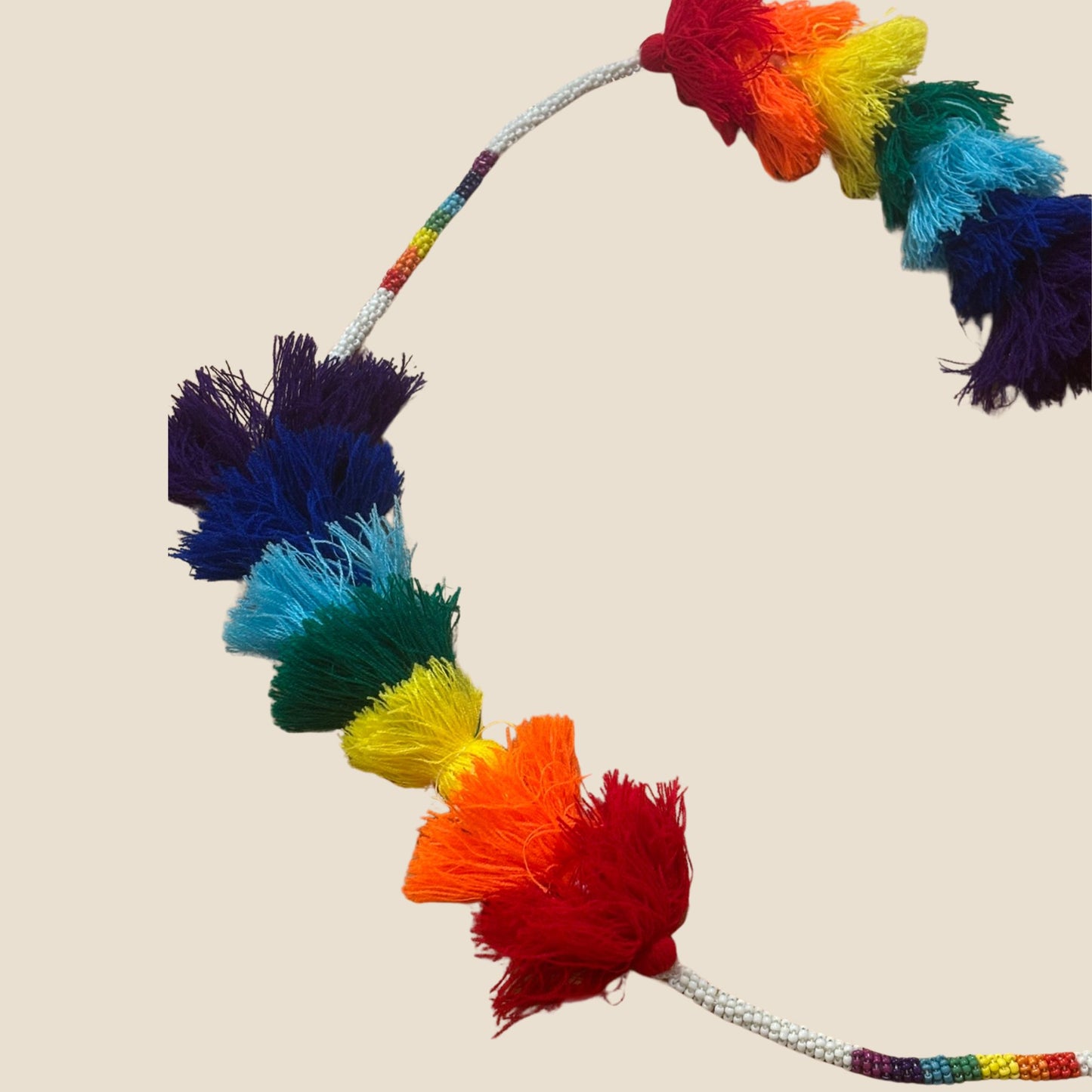 Colorful pom pom home decore on a beige background