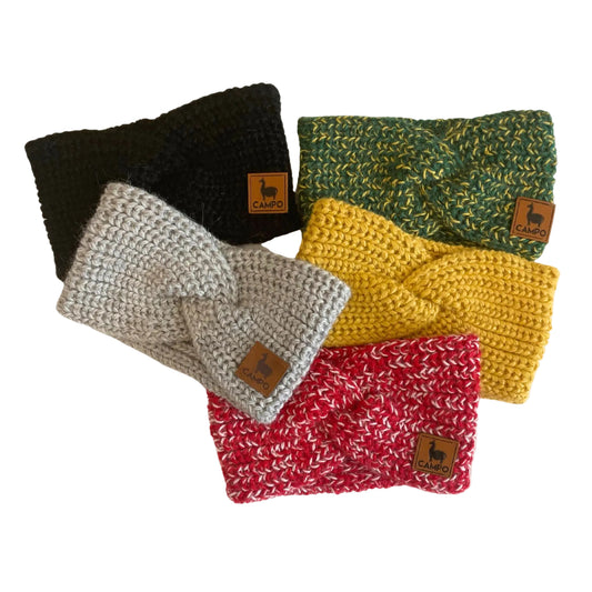Five twisted headband in black, green, gray, yellow, and red on a beige background.