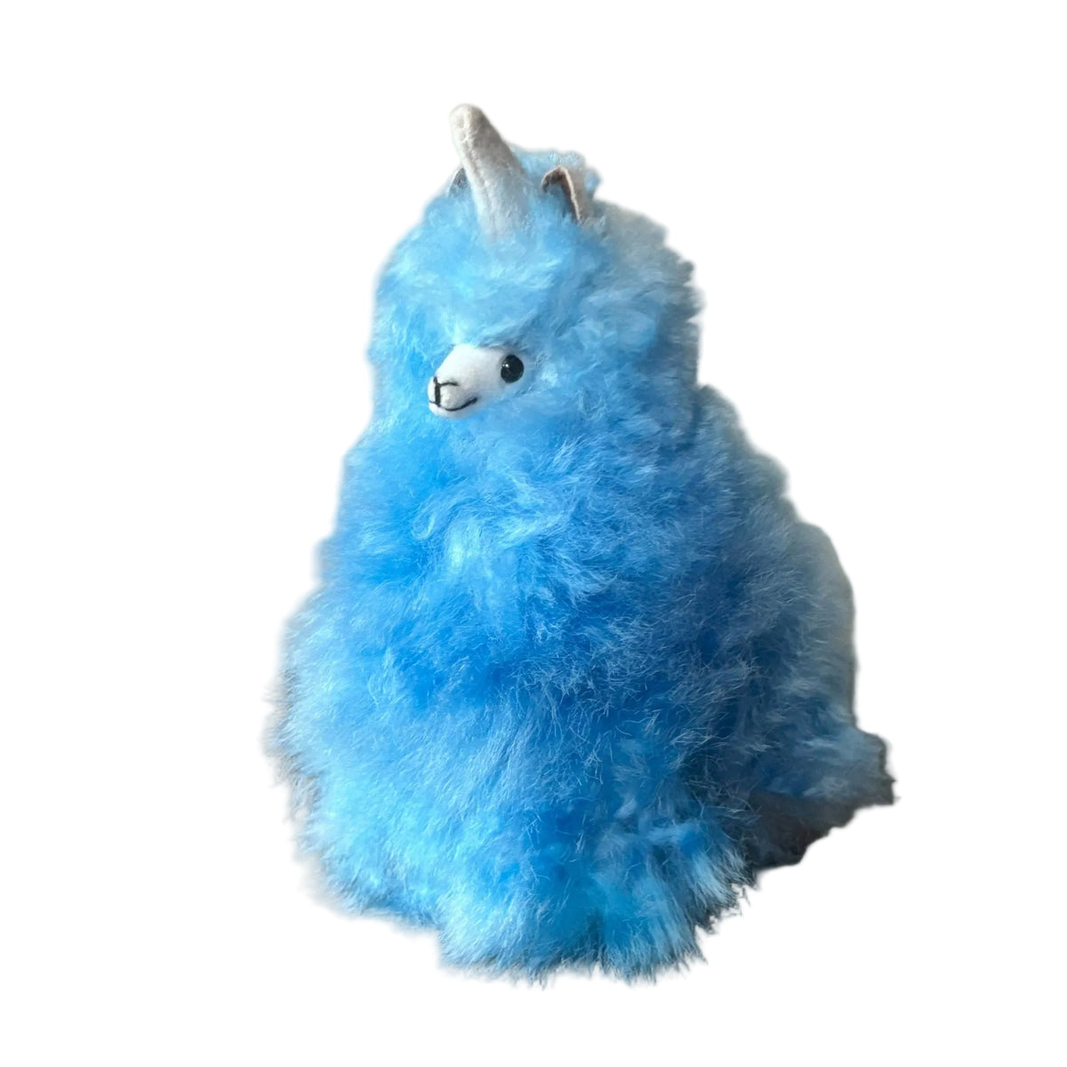 Blue plush toy with a unicorn horn on a beige background