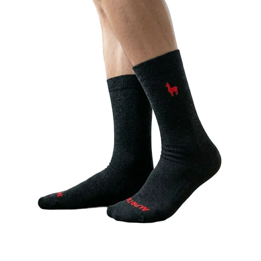 Black socks with red logo and text on a beige background