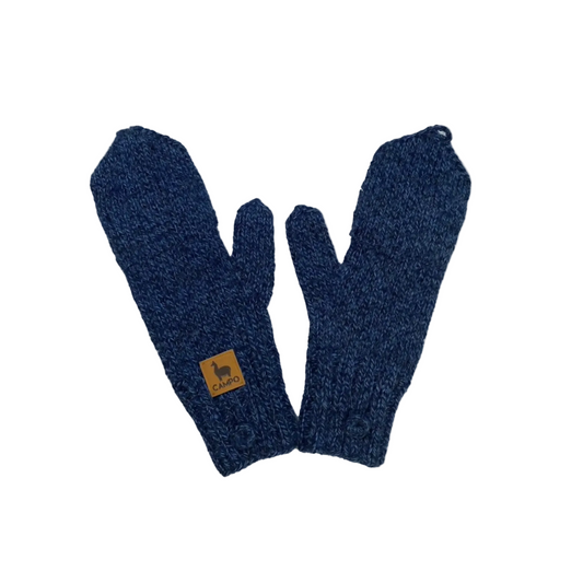 Pair of blue knitted gloves with a brand label on a beige background
