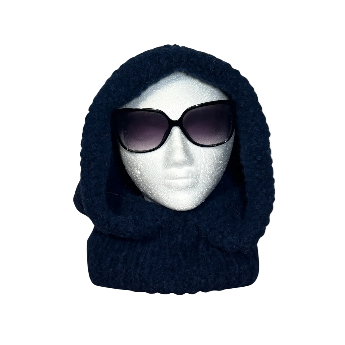 Navy blue knitted balaclava on a mannequin head with sunglasses against a beige background