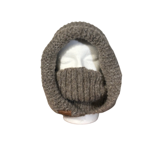 Knitted balaclava on a mannequin head against a beige background