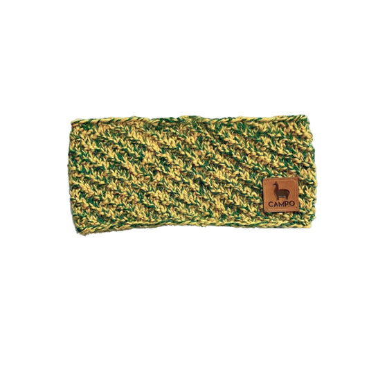 Green and yellow knitted headband with a brown label on a white background