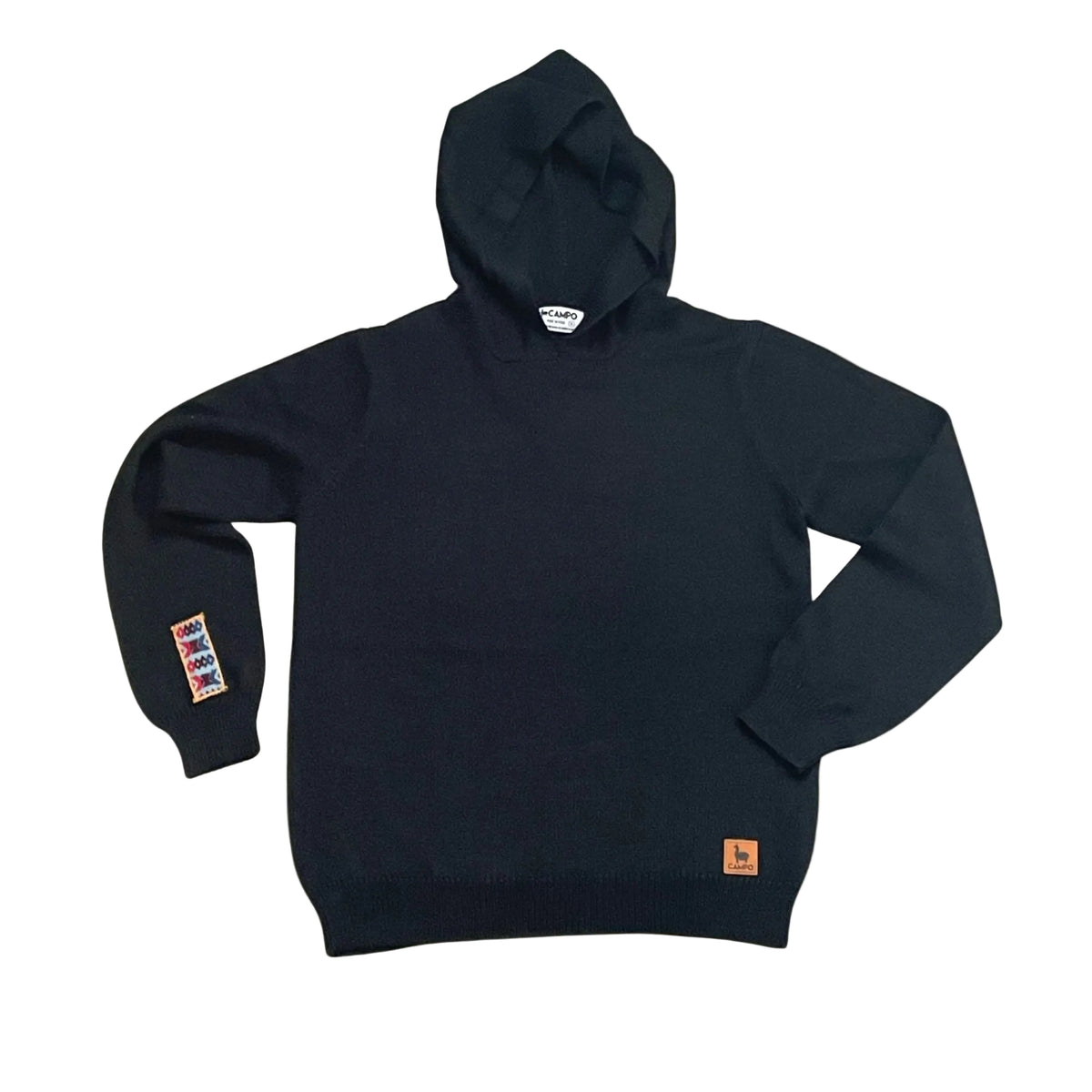 Black hoodie with visible branding on a beige background