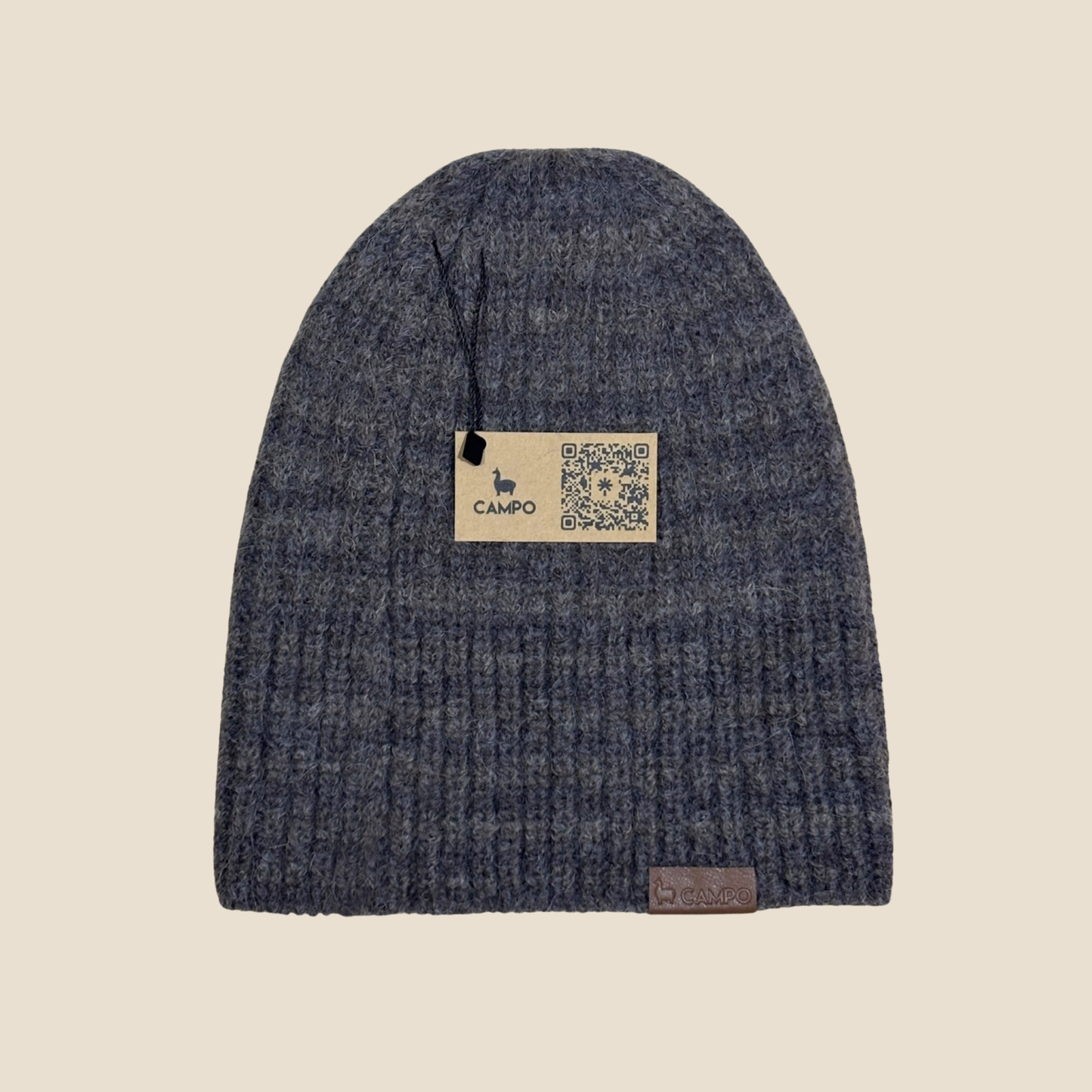 Blue knit beanie with a 'Campo' label on a beige background