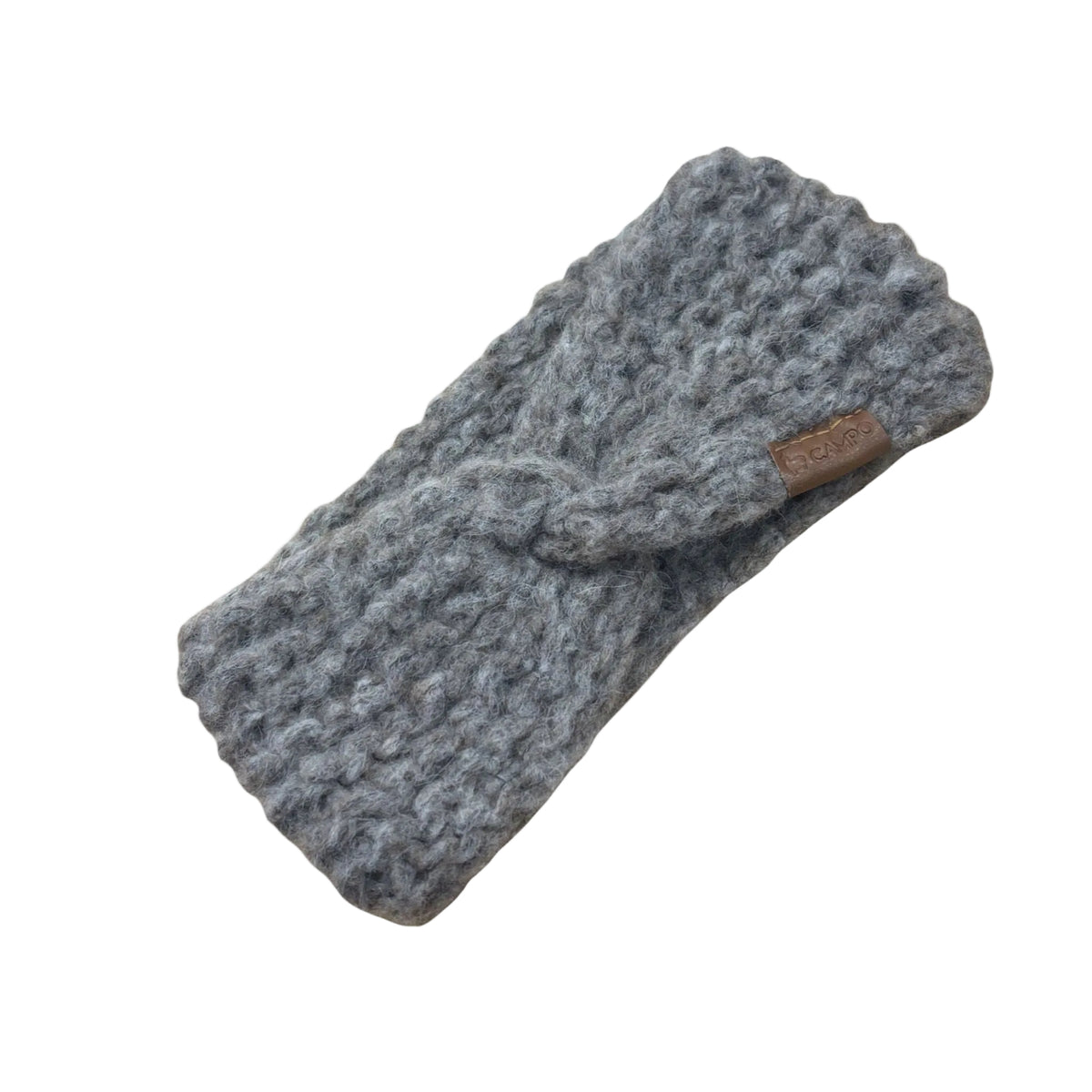 Oatmeal twisted headband with a brown label on a beige background