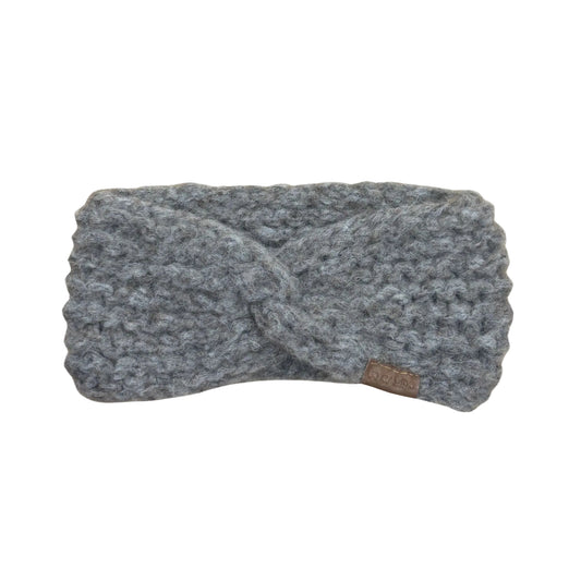 Oatmeal twisted headband with a brand tag on a beige background