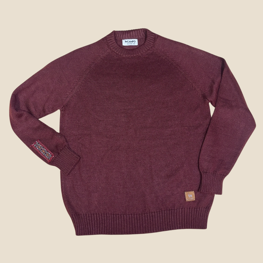 Merlot sweater with brand labels on a beige background