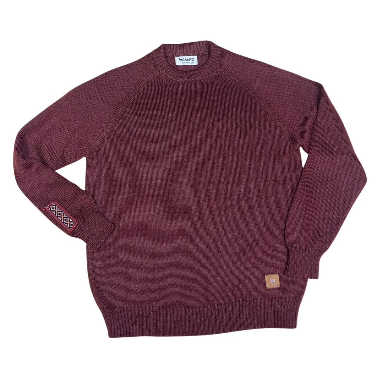 Merlot sweater with brand labels on a beige background