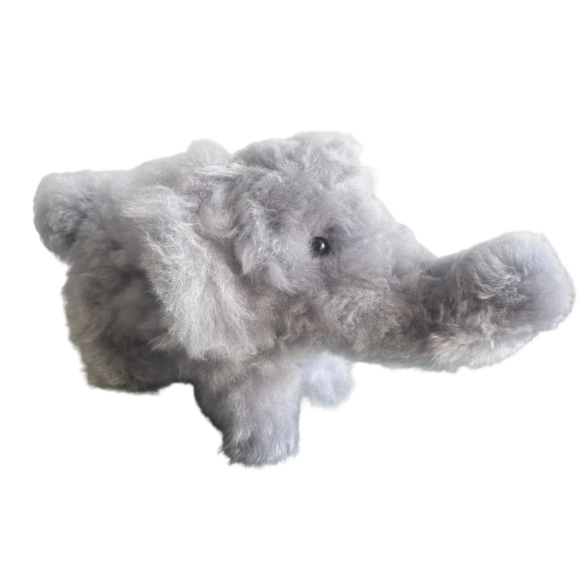 Plush elephant toy on a beige background