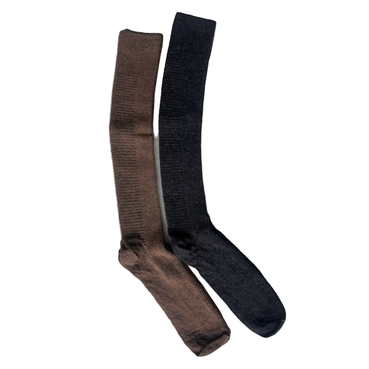 Brown and black knee-high socks on a textured gray surface