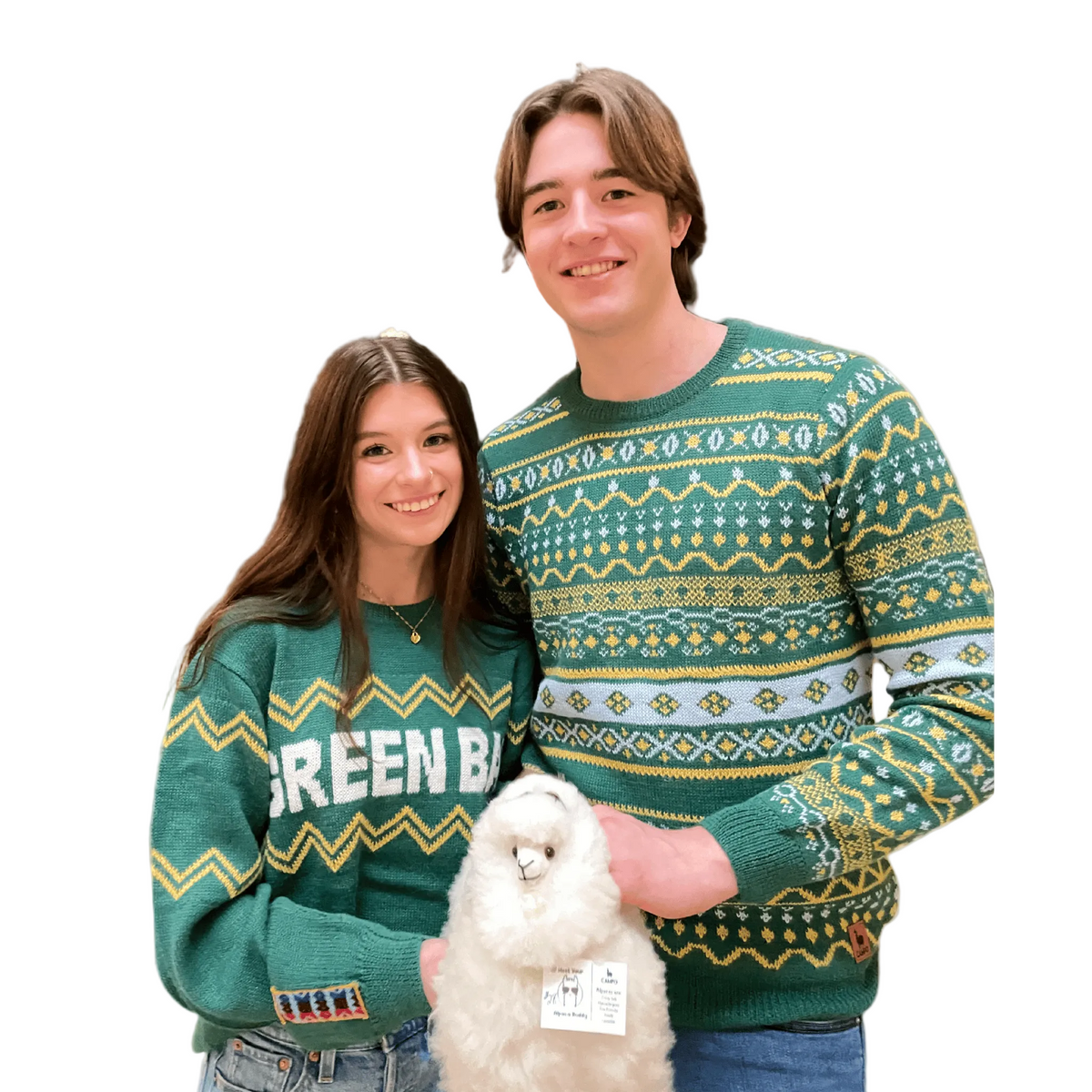 Two people wearing green patterned sweaters with a Alpaca on a beige background