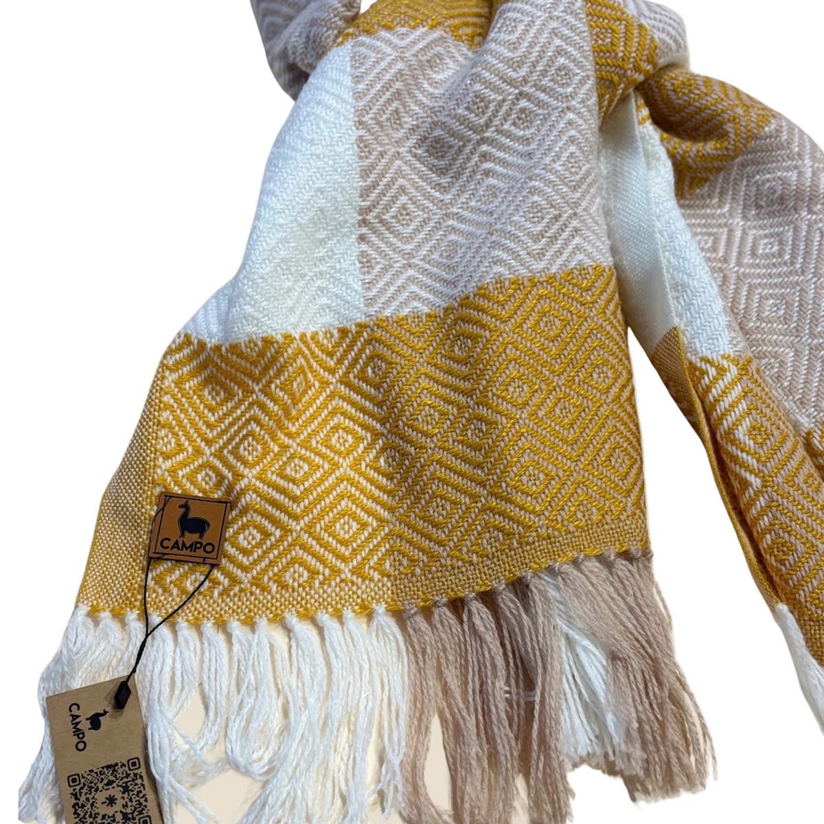 Yellow and white patterned scarf with fringes and a visible brand tag on a beige background