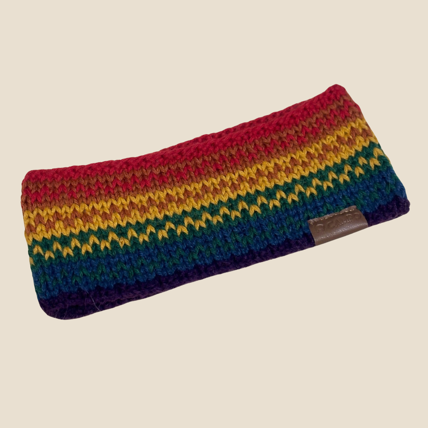 Multicolored striped pouch with a brown patch on a beige background