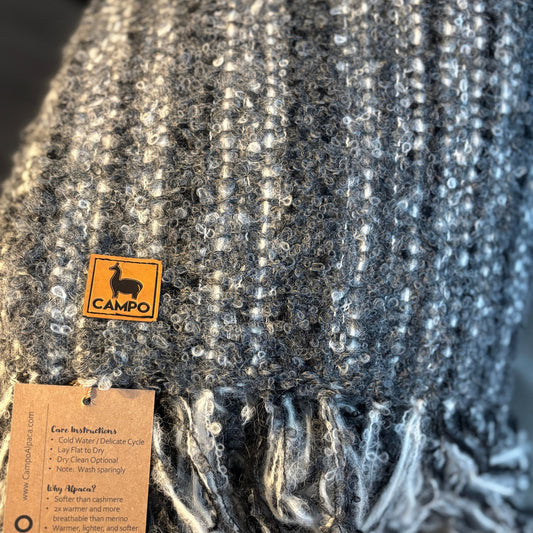 Close-up of a textured fabric with a 'Campo' label and care instructions tag.