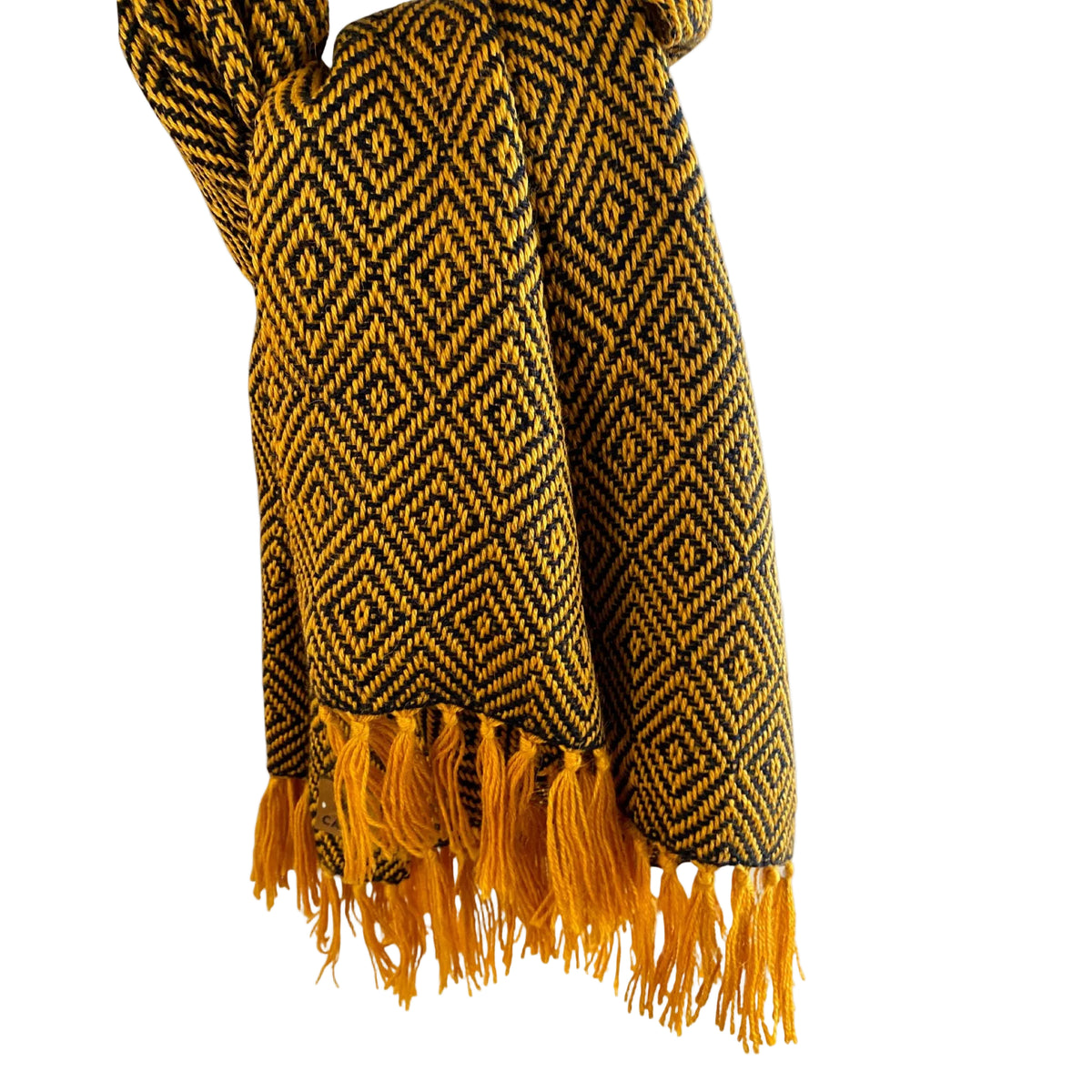 Yellow and blue patterned scarf with fringes on a beige background