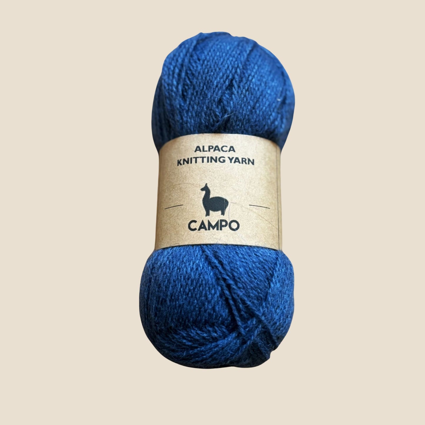 Denim alpaca knitting yarn with 'Campo' label on a beige background