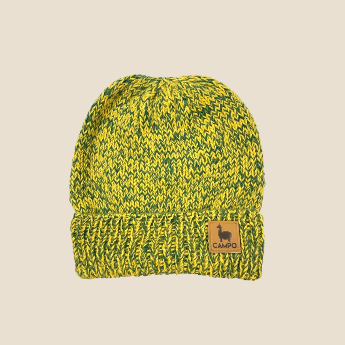 Green and yellow knit beanie with a Campo logo on a beige background