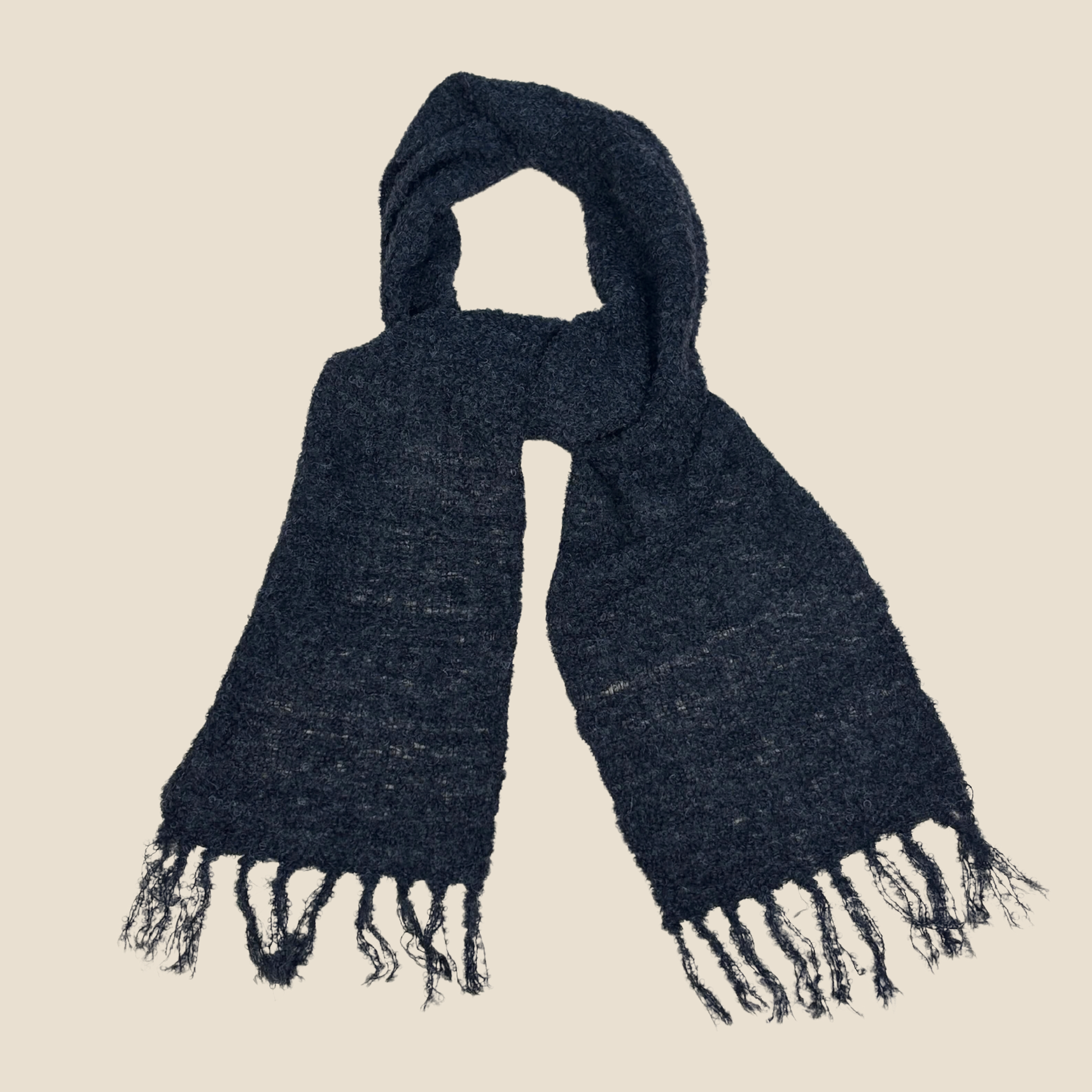 black scarf with fringes on a beige background