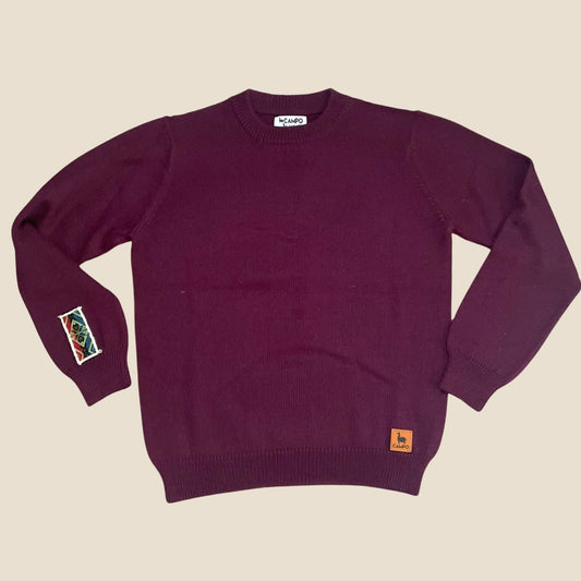 Eggplant sweater with small Campo logos on a beige background