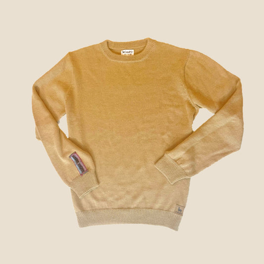 Hazelnut sweater with a brand label on a beige background