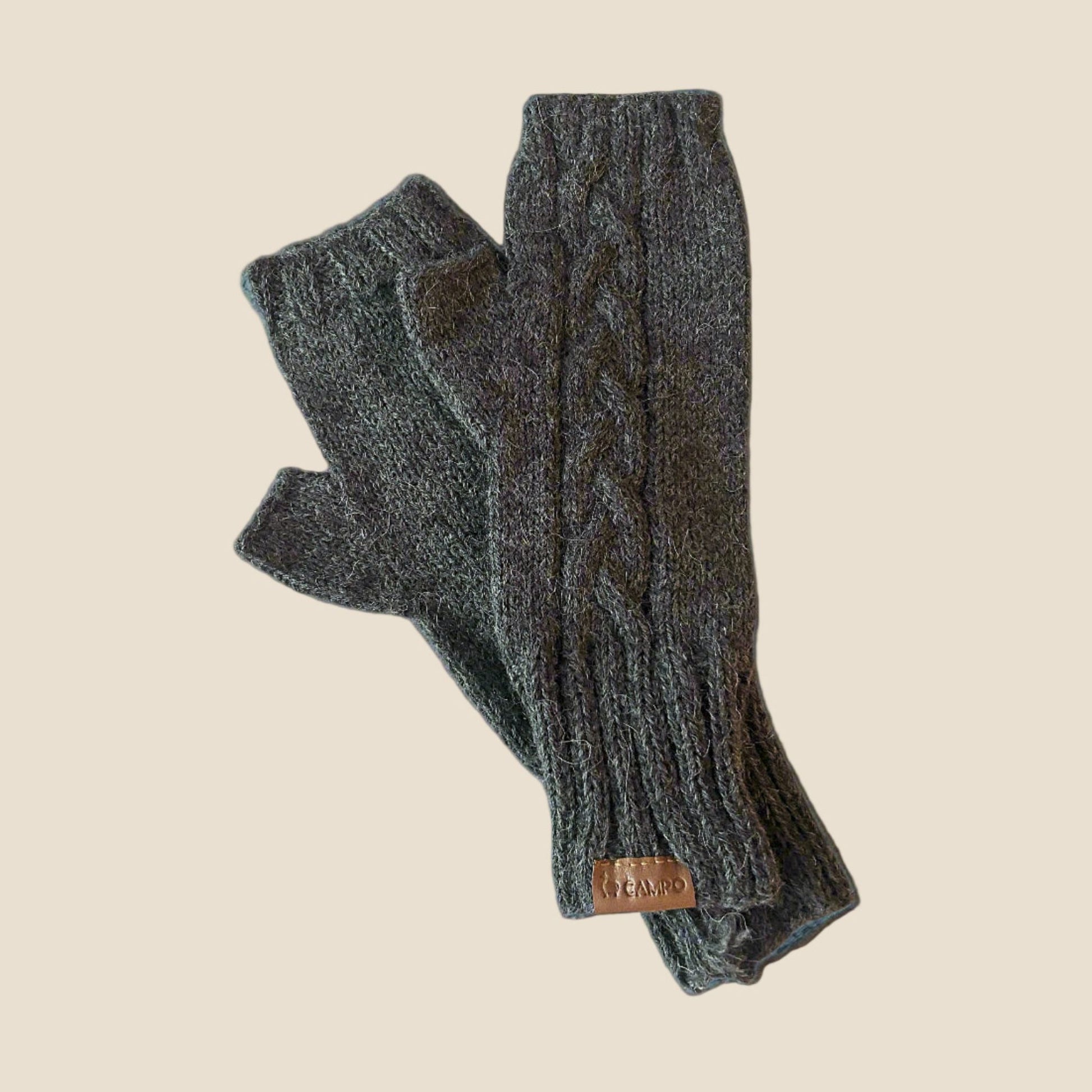 Pair of gray knitted fingerless gloves on a beige background