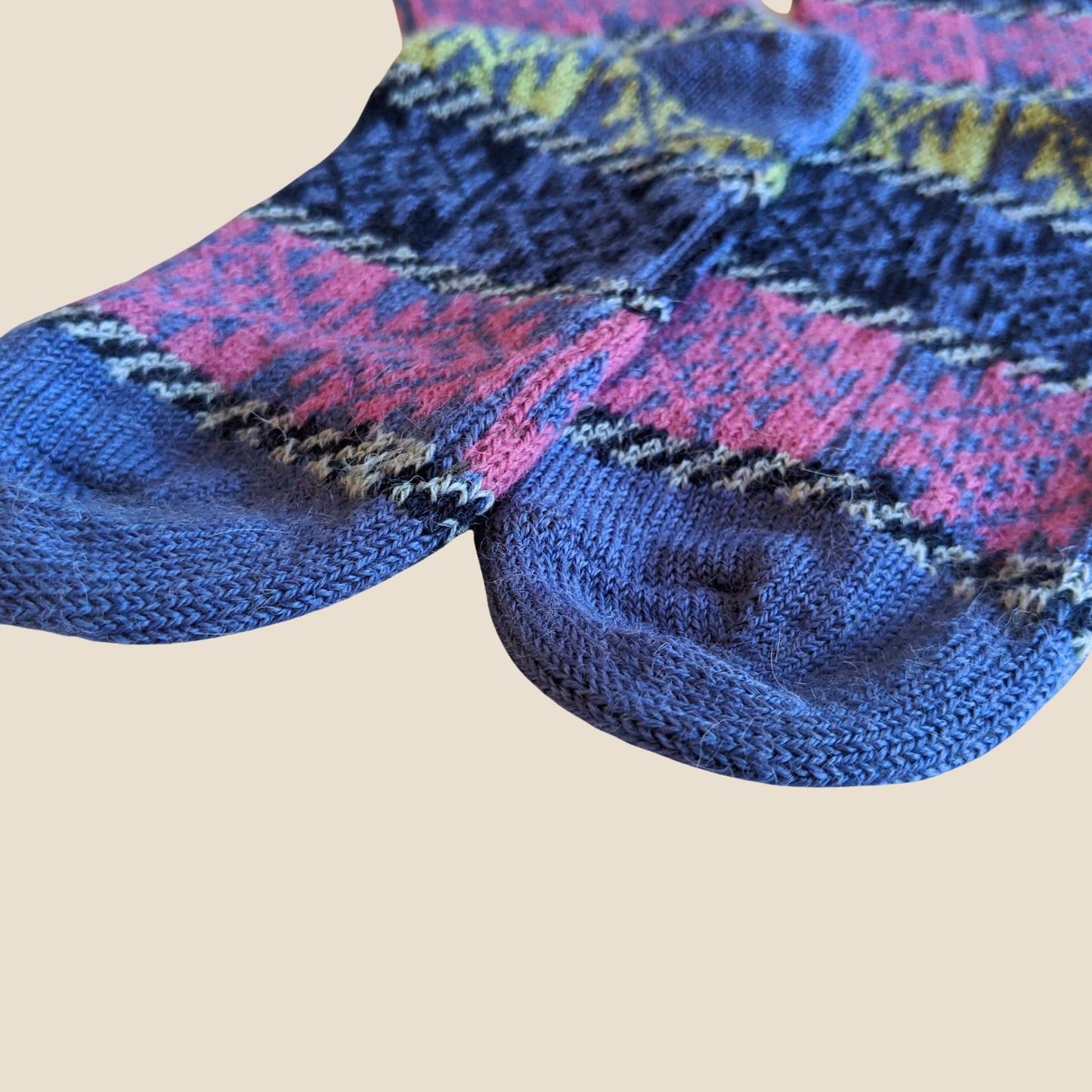 Pair of patterned socks on a beige background