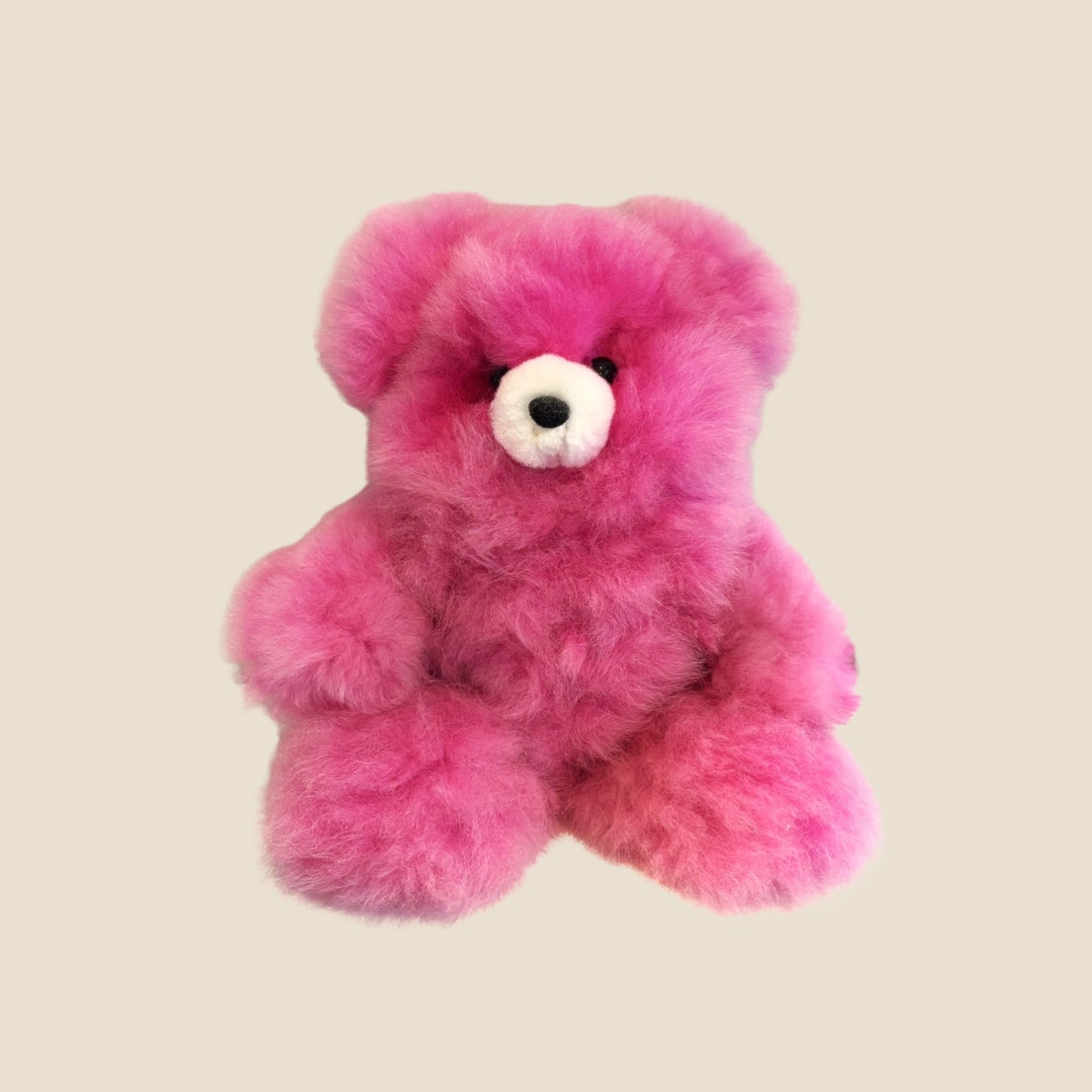 Pink teddy bear on a beige background
