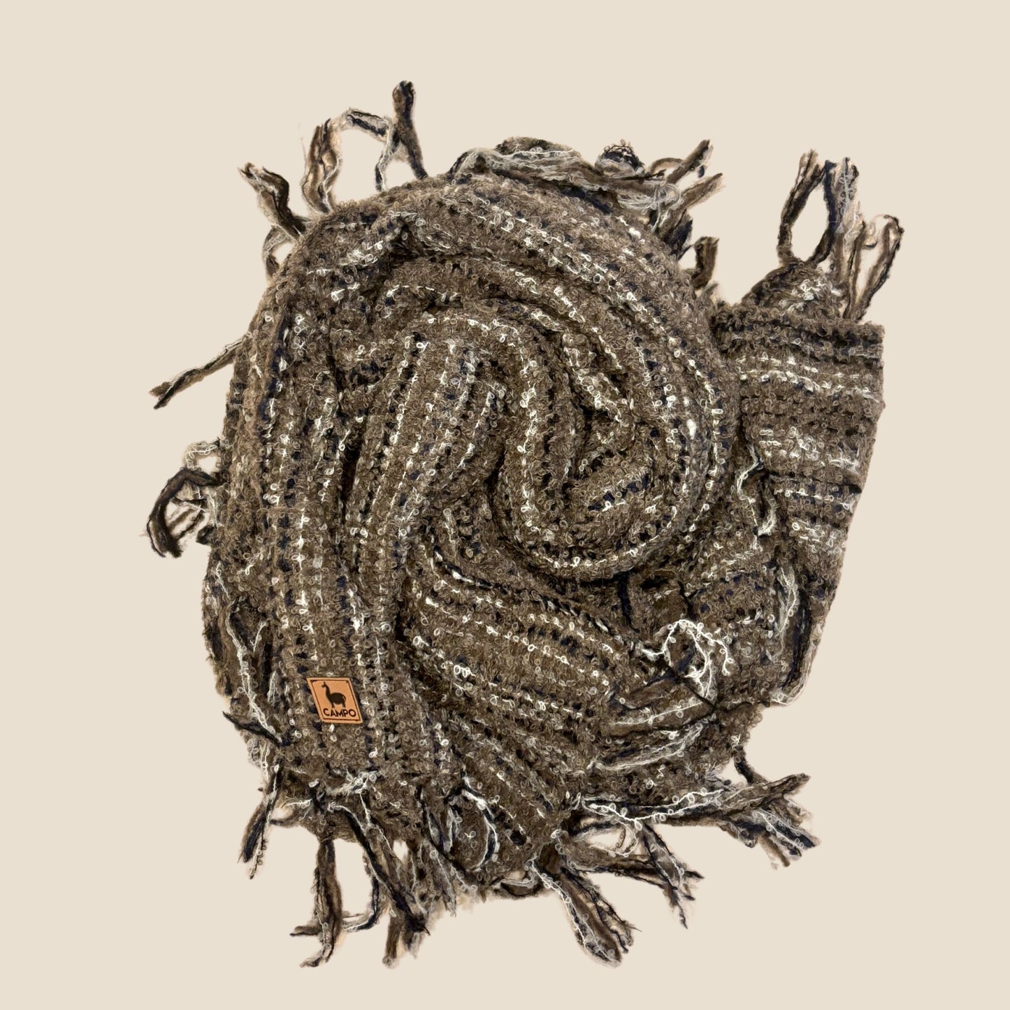 Textured scarf with tassels on a beige background