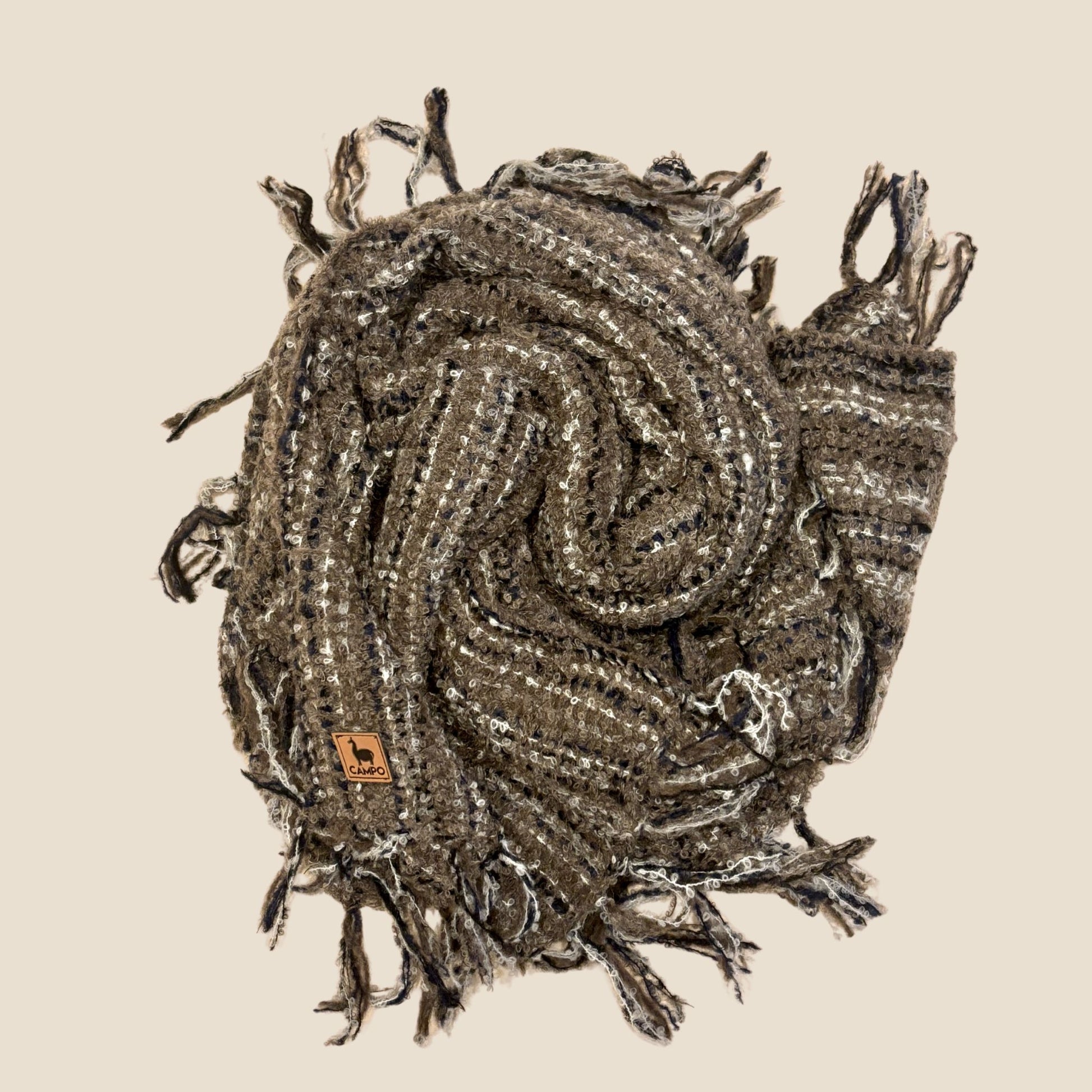 Textured scarf with tassels on a beige background