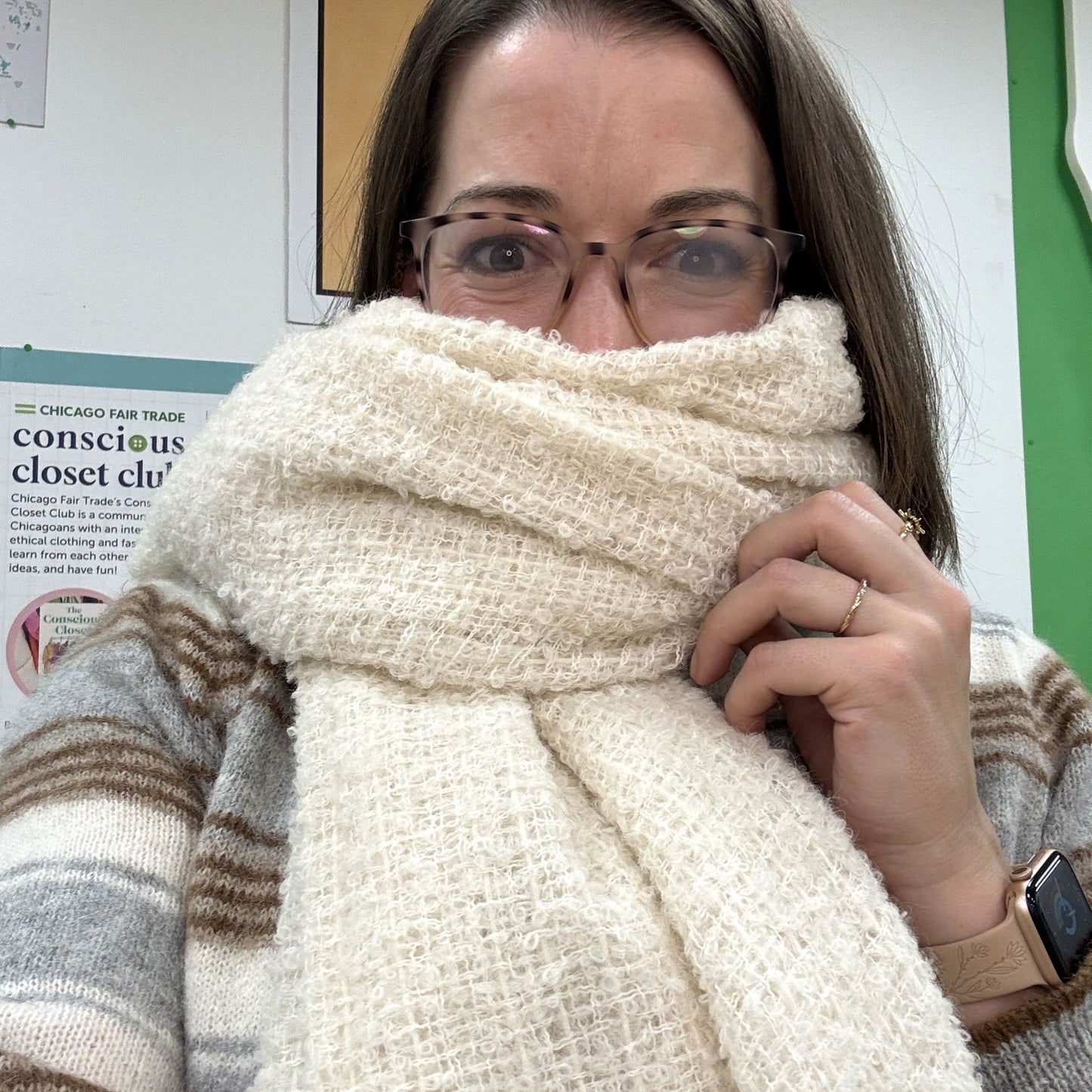 Person wearing a large white scarf over their face with a blurred background