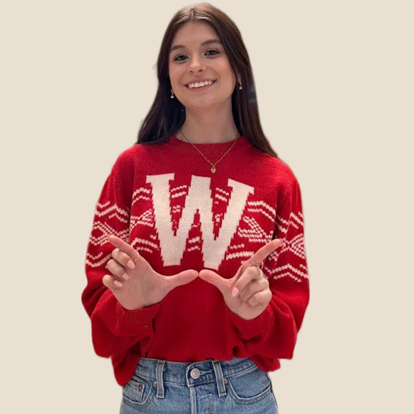 Person wearing a red sweater with a large 'W' on a beige background