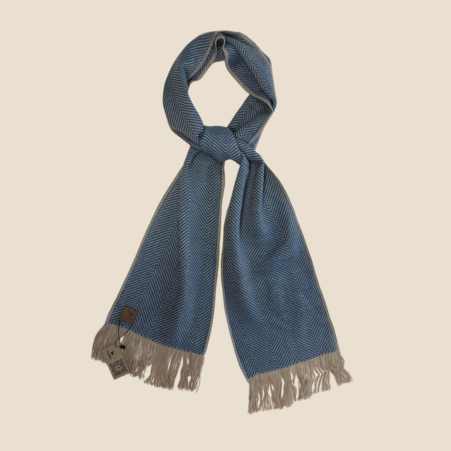 Blue herringbone patterned scarf with fringes on a beige background