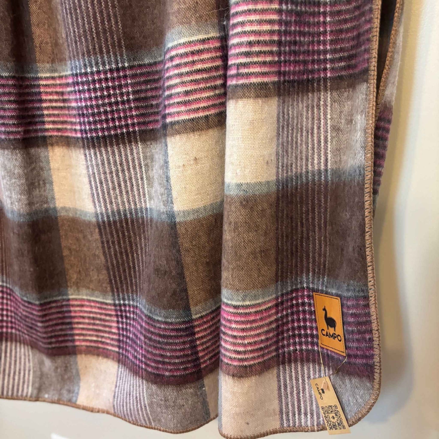 Plaid fabric with a visible brand label on a white background