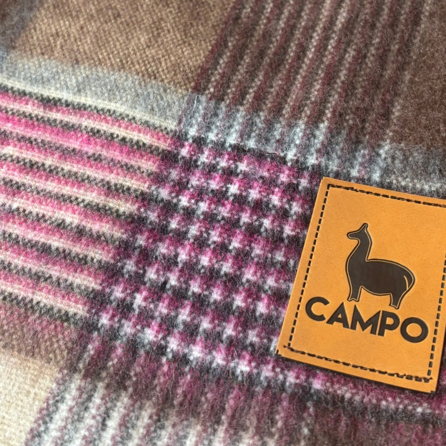 Close-up of a checkered fabric with a 'Campo' brand label.