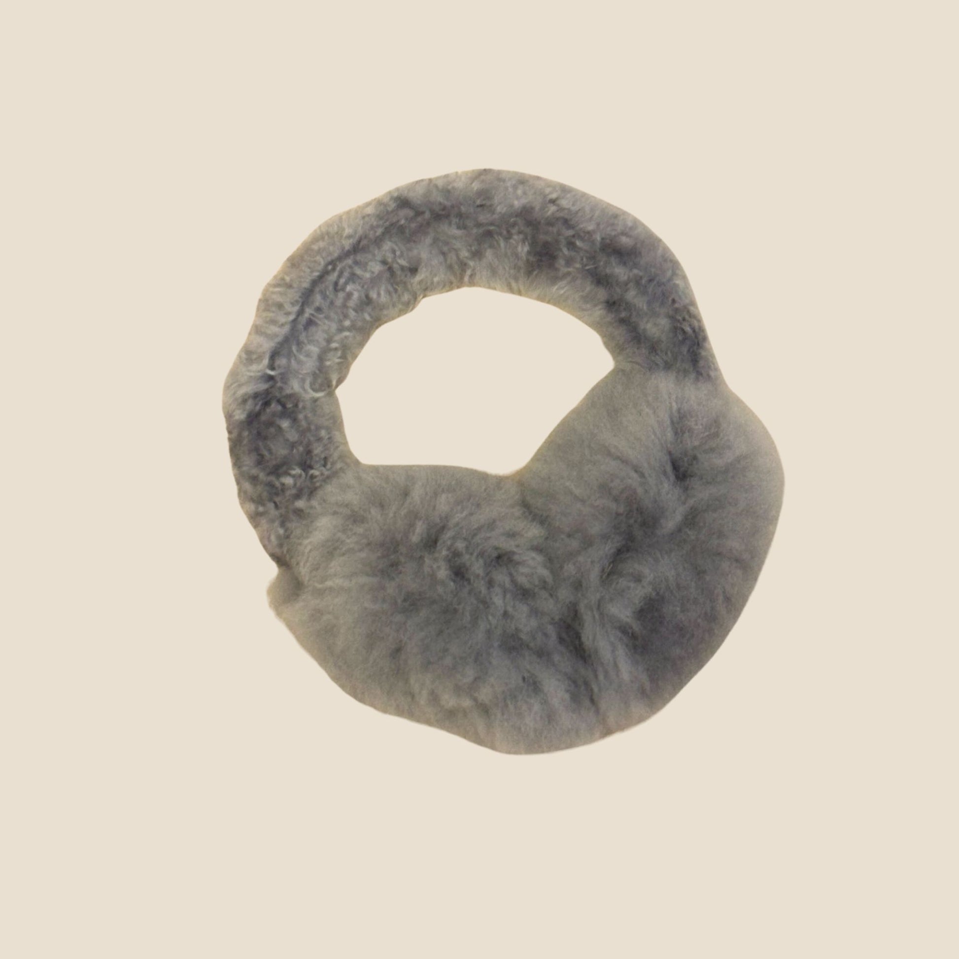 Silver ear muffs on a beige background