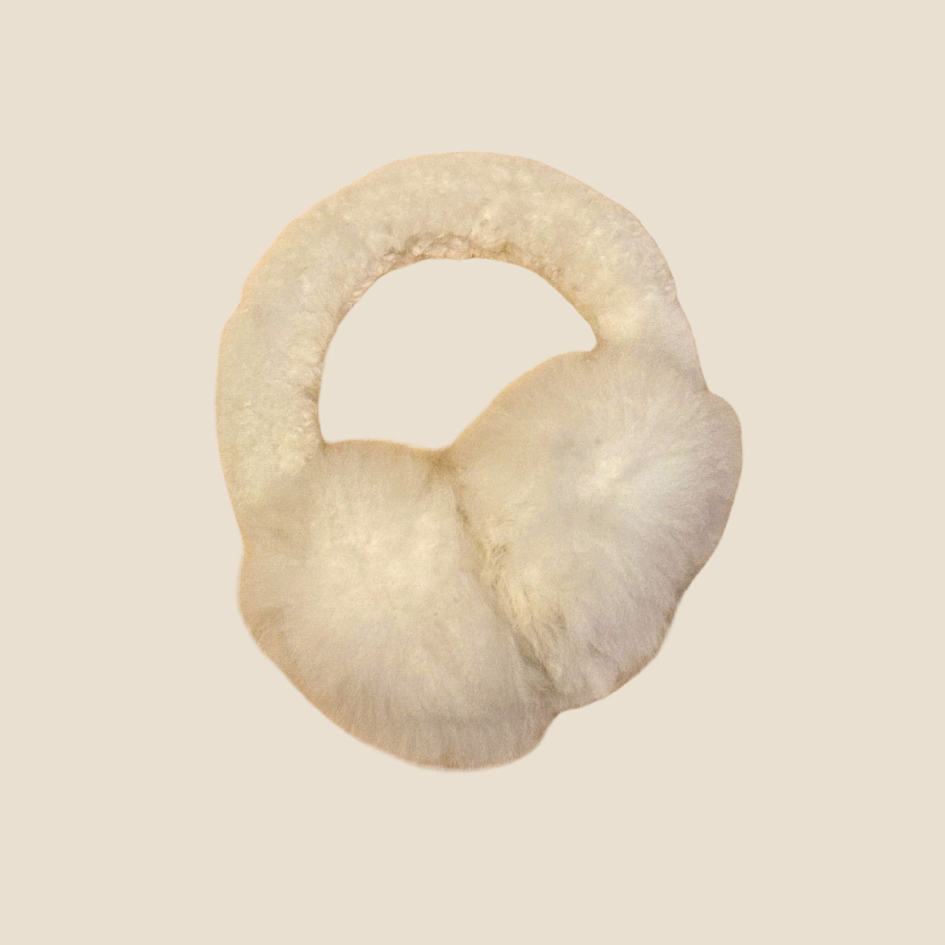 White ear muffs on a beige background