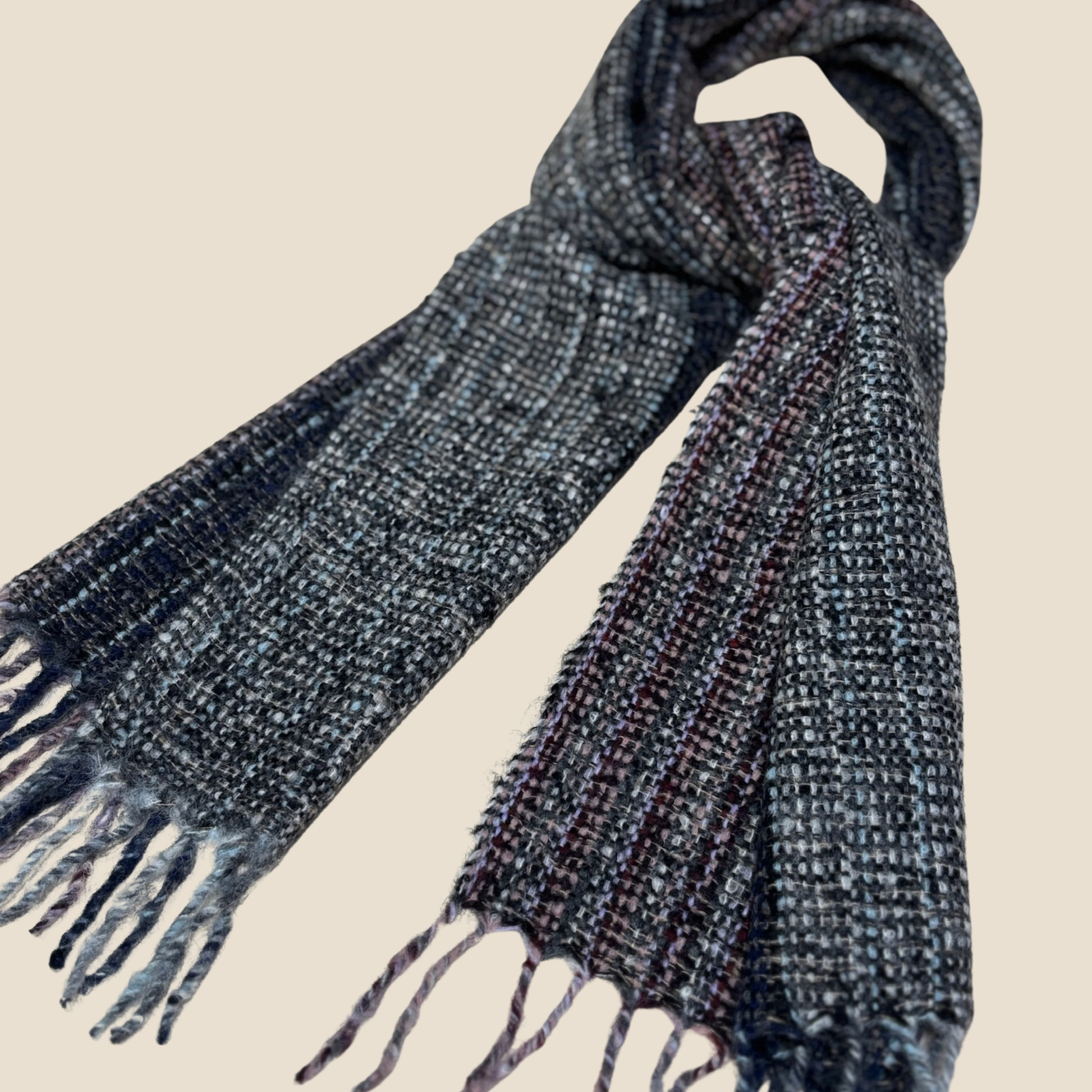 Textured scarf with fringes on a beige background