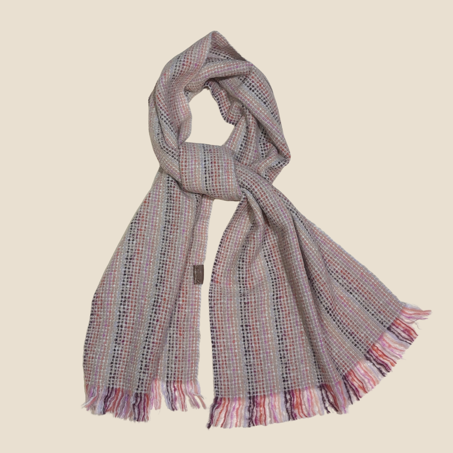 Plaid scarf with fringes on a beige background
