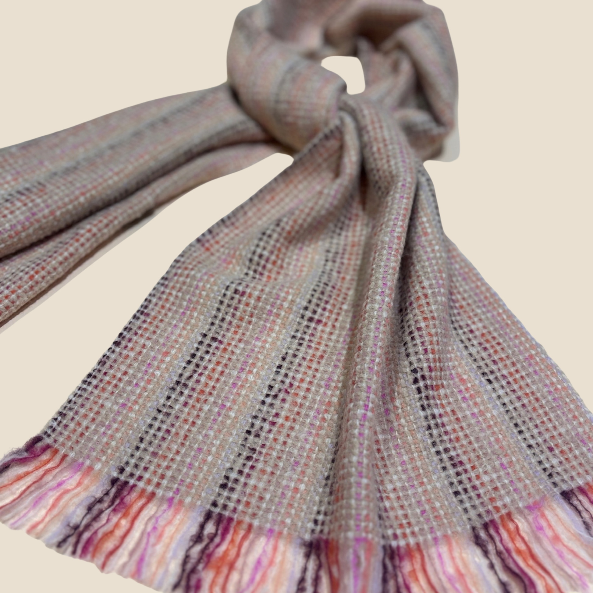 Textured scarf with multicolor fringe on a beige background