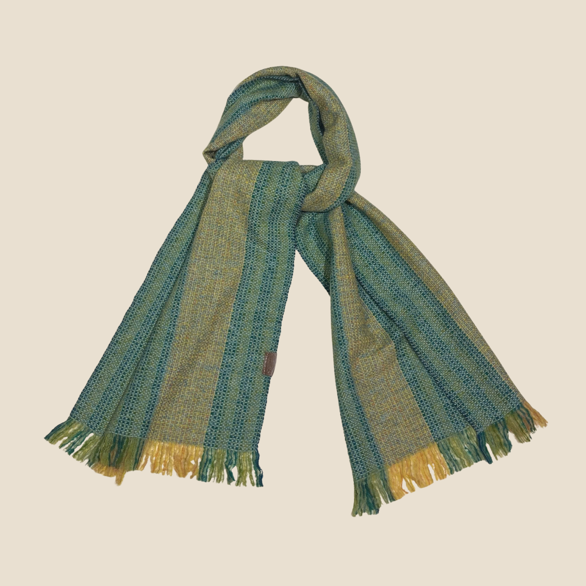Striped scarf with green and blue pattern on a beige background