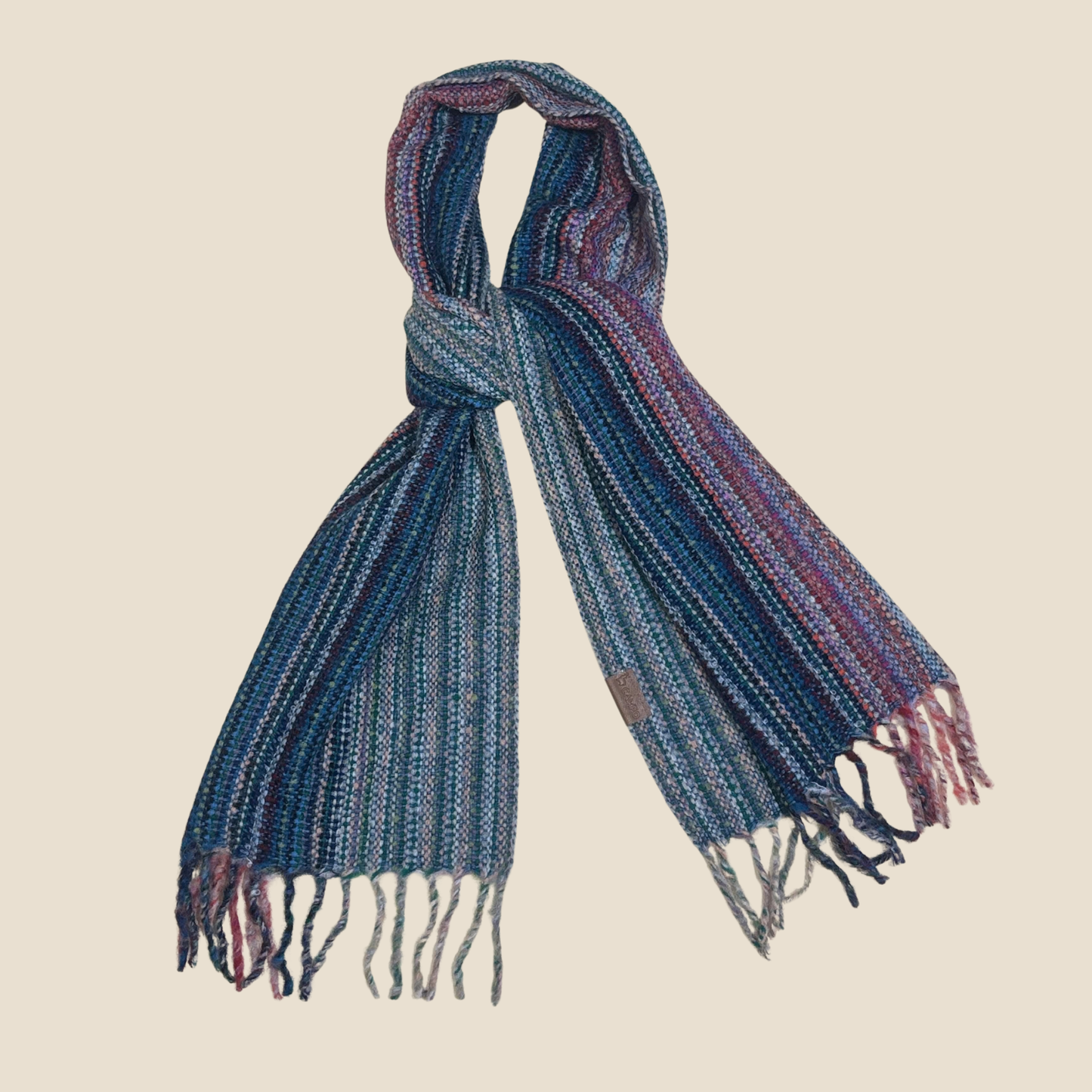 Blue and purple striped scarf with fringes on a beige background