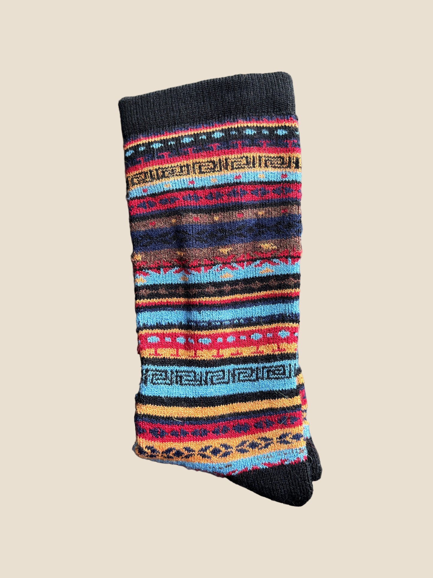 Multicolored striped sock on a gray surface